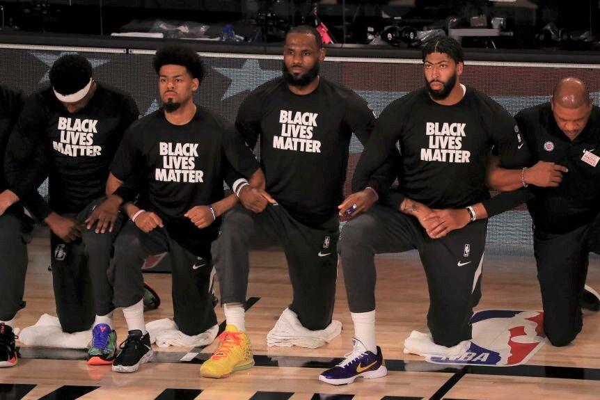 LeBron James and the Lakers players take a knee during the anthem before their game against the Clippers on June 30.