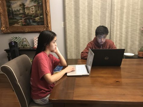 Sophomore Nick Kim works on homework alongside his older sister.