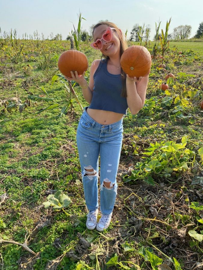Junior Emily Levine spends her day at Butlers Orchard in the pumpkin patch.