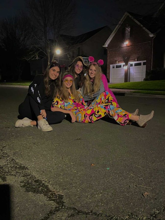 Freshman Zoe Heller hangs out with her sister, senior Tamara Heller, and her friends, senior Eleni Jones and senior Anna Daraselia, on Halloween night.