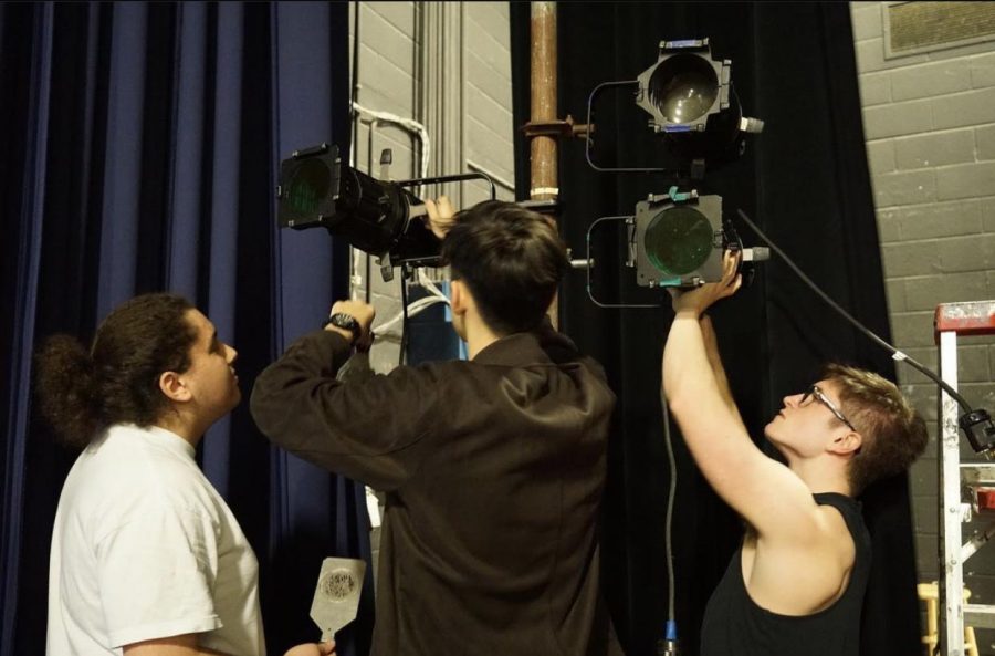 Ben Mash, David Kolb and Stephen Rosov adjust lights used for Freaky Friday, which was performed during the 2019-2020 school year.