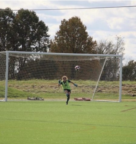 Lindsey Walter blocks the ball at a soccer match.