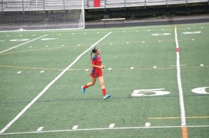Jessica Winson warms up for her JV soccer game as a freshman.