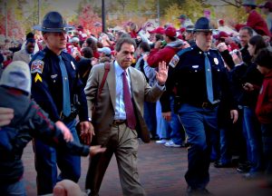 Alabama Head Coach Nick Saban excites the crowd as he enters the stadium for a home football game. Saban has been supportive of DeVonta Smith.