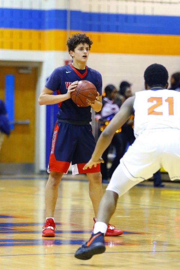 Senior William Margarites takes the ball up the court last year against Watkins Mill during the 2019-2020 season.