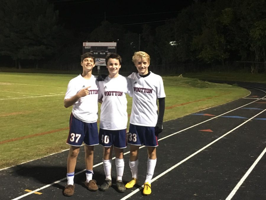 Juniors Ethan Cohen and Nick Jones along with senior Jeremy Ullman celebrate after a game against Quince Orchard in 2018.