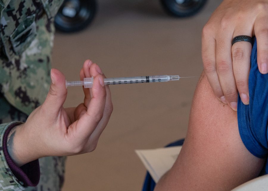 A patient receives a dose of the Pfizer vaccine at a Navy medical center Dec. 15, 2020.