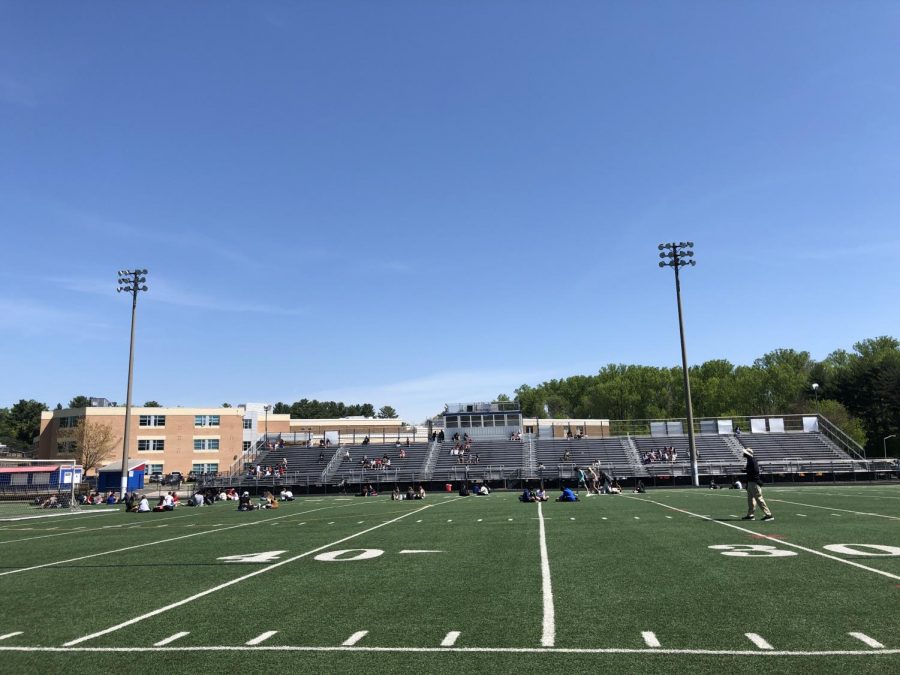 Students who opted to go in-person eat lunch on the football field on Apr. 27. On the same day, the CDC has updated guidelines stating that masks arent needed for small gatherings outdoors for those who are fully vaccinated, but are still recommended for those who arent vaccinated yet.