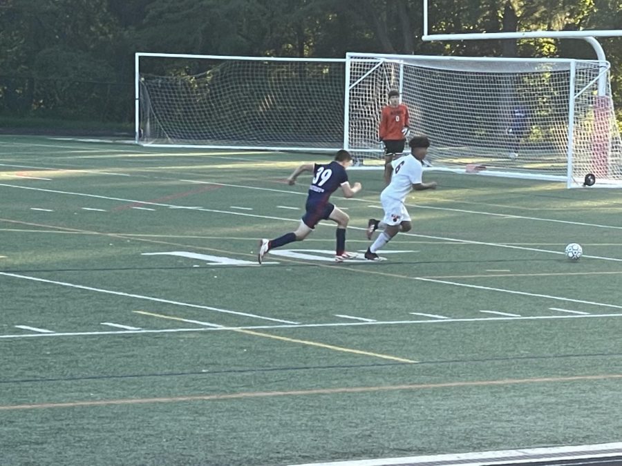 Freshman Noah Friedman runs for the ball minutes before the end of the half against Rockville.