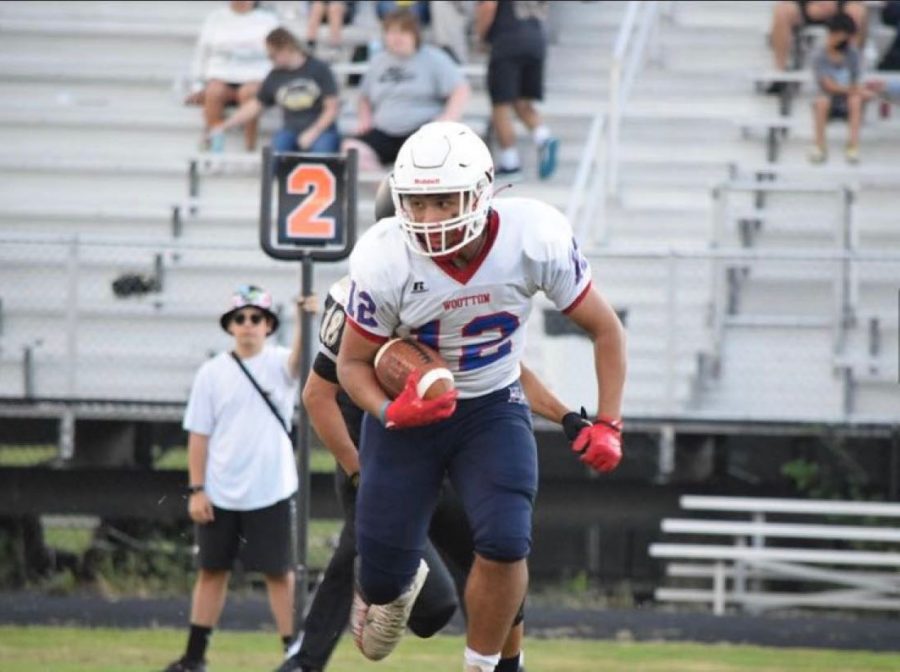 Sophomore running back Mathew Cortes takes a handoff on second down in the Sept. 9 game at Poolesville. Cortes would end up having 14 carries for 97 yards for the Patriots.