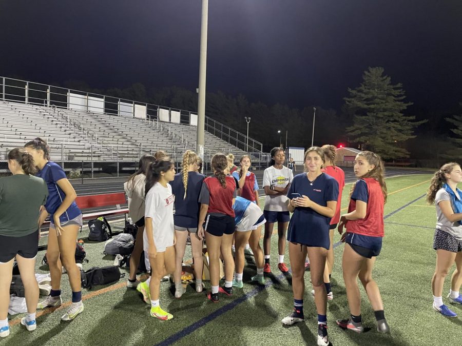 The girls varsity soccer team wraps up a late night practice. Athletes are not required to wear masks outdoors.