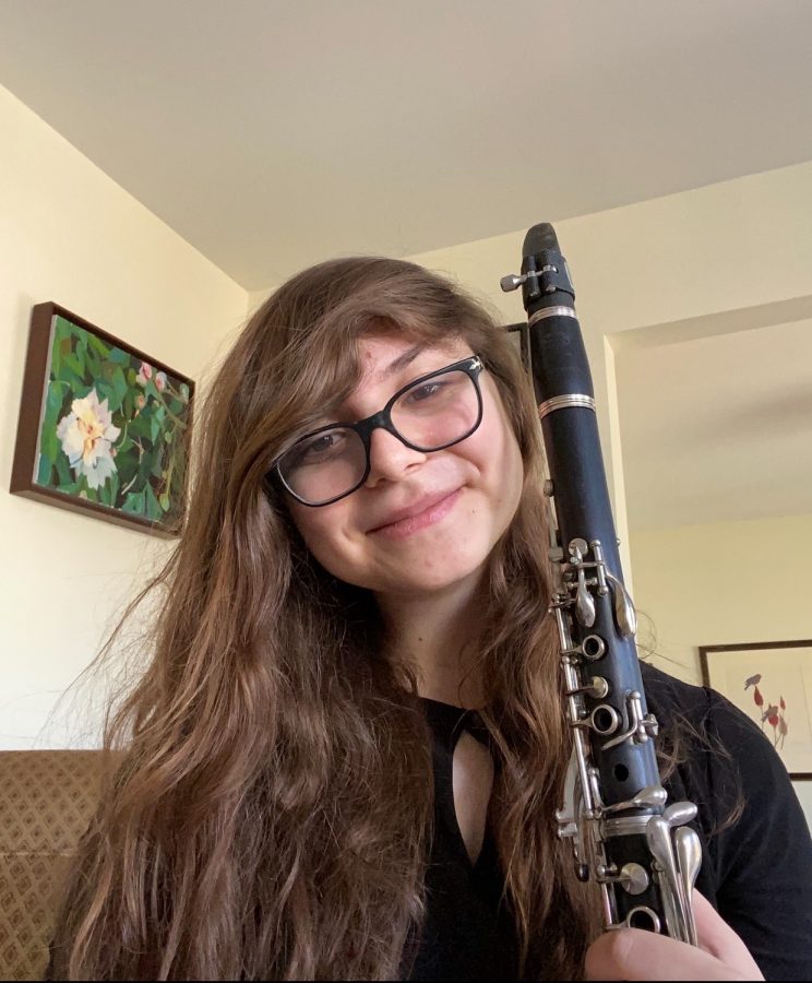 Junior Sara Bock warms up her clarinet before a performance.
