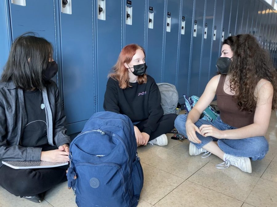 Juniors Kate Thepnorarat, Rachel Nanos and Maddie Press wear their masks after finishing their lunches to keep each other safe.