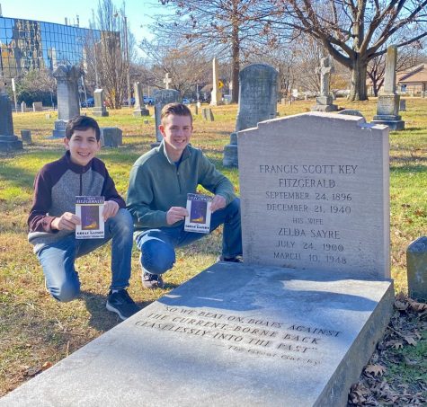Senior Josh Freedman and freshman Charles Freedman next to F. Scott Fitzgerald’s Grave holding copies of The Great Gatsby.