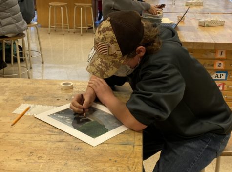 Freshman Ethan Mahoney works on a drawing in 2D Studio Art.