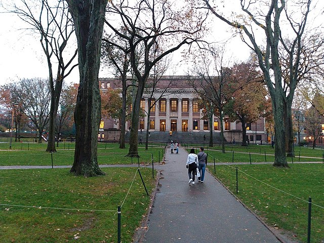 Students+and+visitors+walk+along+paths+at+Harvard+University.