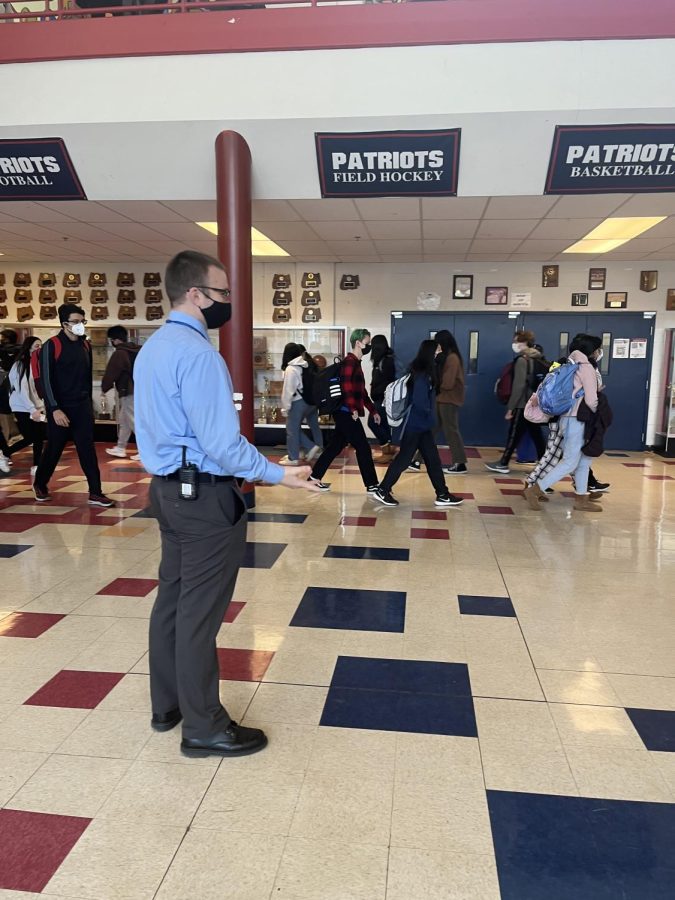 Principal intern Brad Rohner observes students transitioning between classes in the Commons.