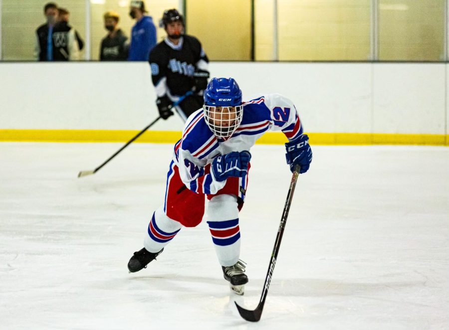 Junior Keanu Yi skates to the puck in a game against Whitman.