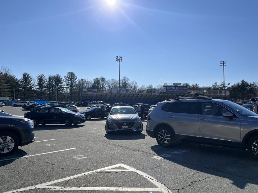 Cars begin to line up and clog the parking lot as students get ready to go home after school.