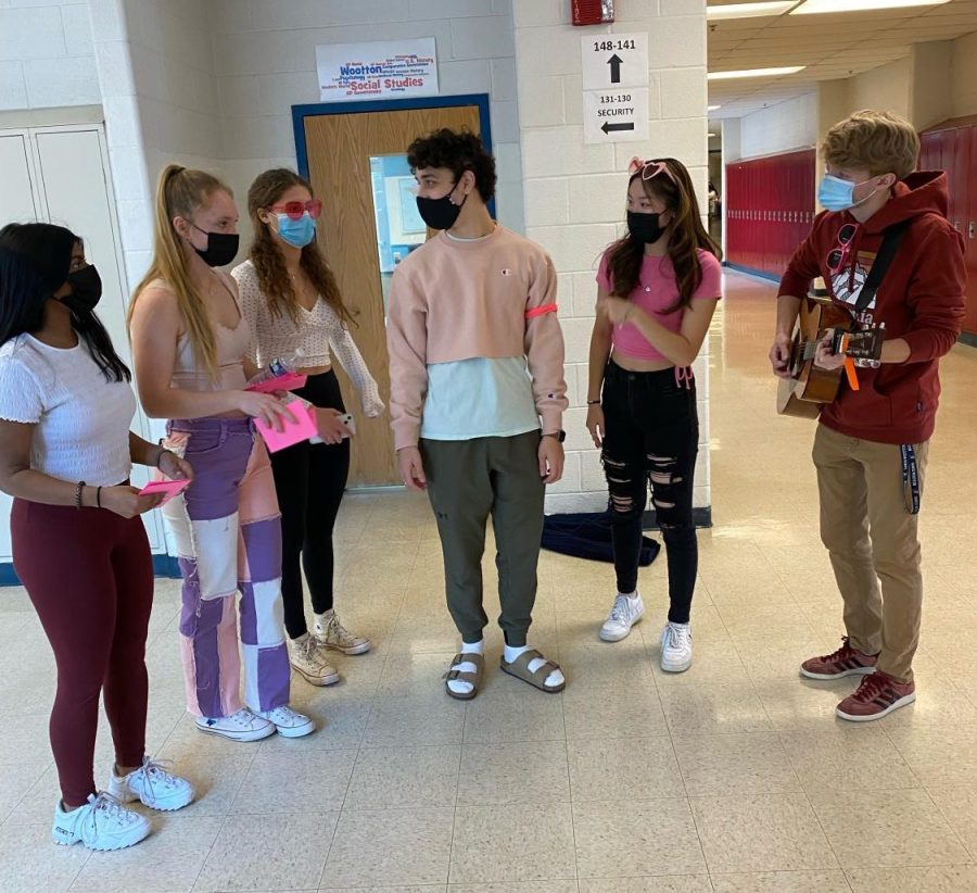 An acapella group of Dhanya Philipose, Lizzie Nelson, Gabriella Wright, Michael Seibert, Fiona Lin and Nick Jones practice their song, Enchanted, by Taylor Swift, before performing their singing Valentine to a recipient in a class.