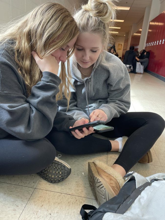 Sophomores Lindsey Mcney and Elsa Liljas compare a math test grade during lunch.