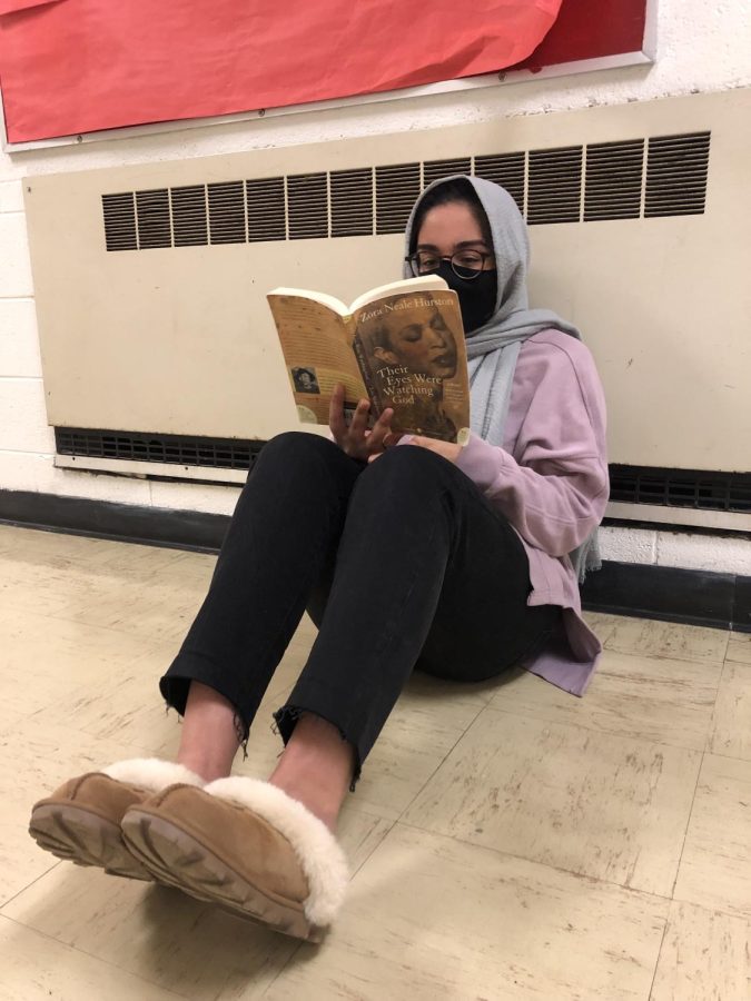Senior Humnah Ibrahim catches up on her AP English Literature reading in her UGG slippers.