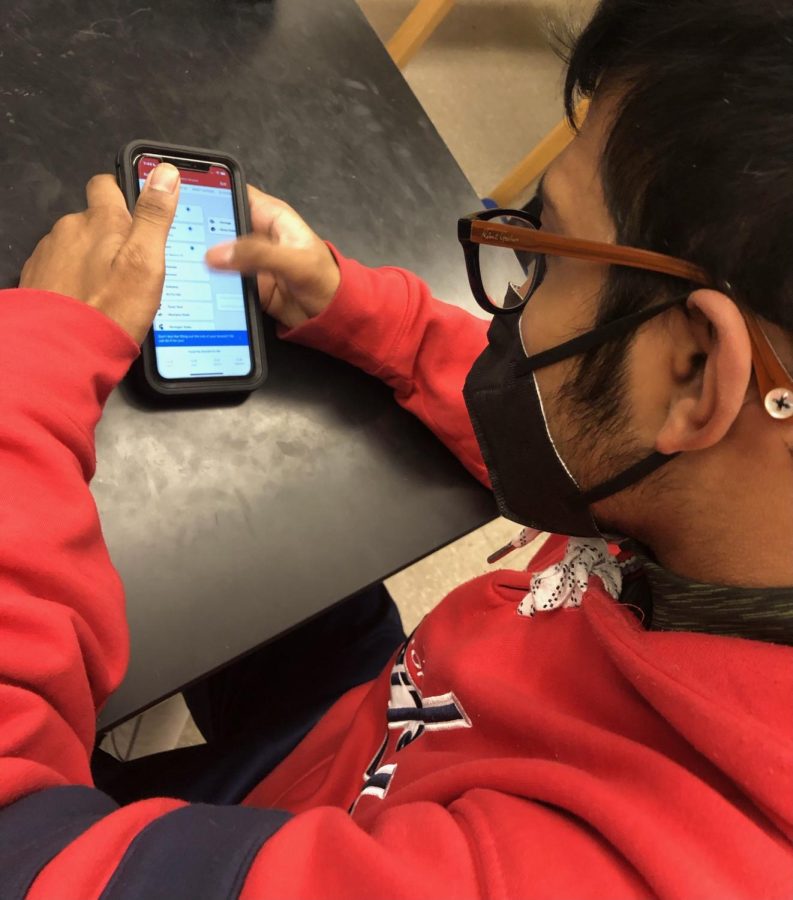 Before his first period physics class, junior Souvik Kar fills out his bracket on the ESPN Tournament Challenge app on his phone. Kar is just starting to fill out the bracket, which typically only takes five to 10 minutes to complete. This is just one of 20 brackets that Kar has done in the last few days. Before filling out his bracket, “ I read info and data about the matchups then compared them,” Kar said.