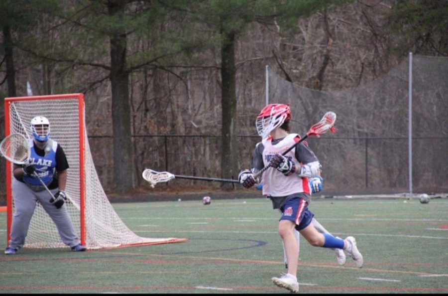 Senior captain Ian Smith on attack looks for an opportunity to score in his scrimmage against Blake on Mar 16.