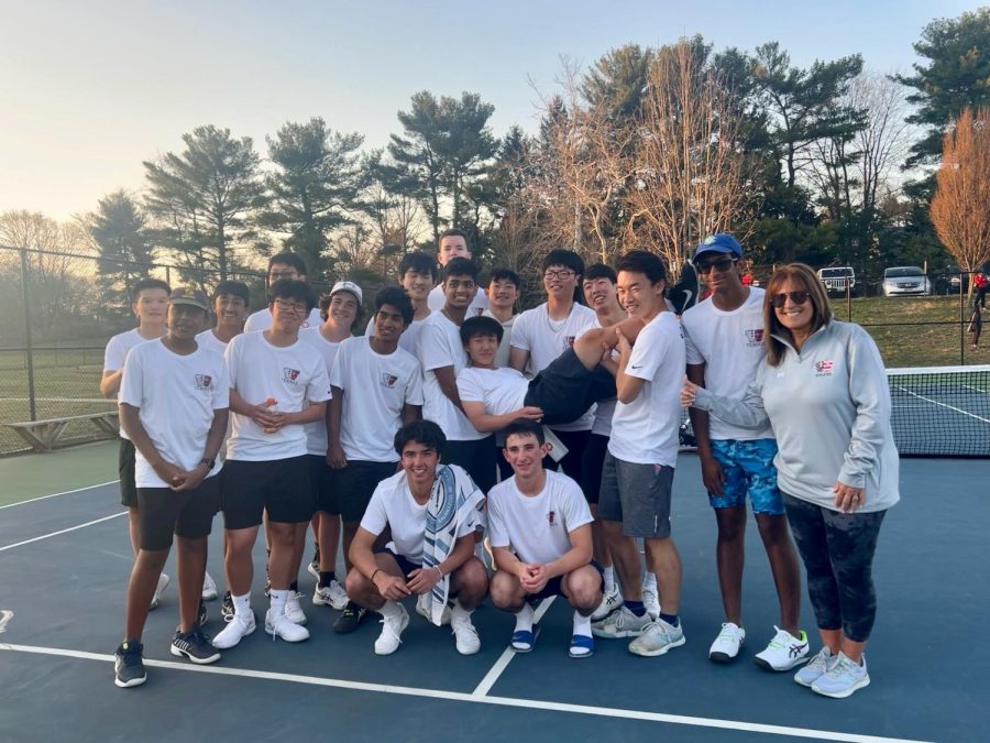 The boys tennis team celebrates after a 7-0 win against Quince Orchard.