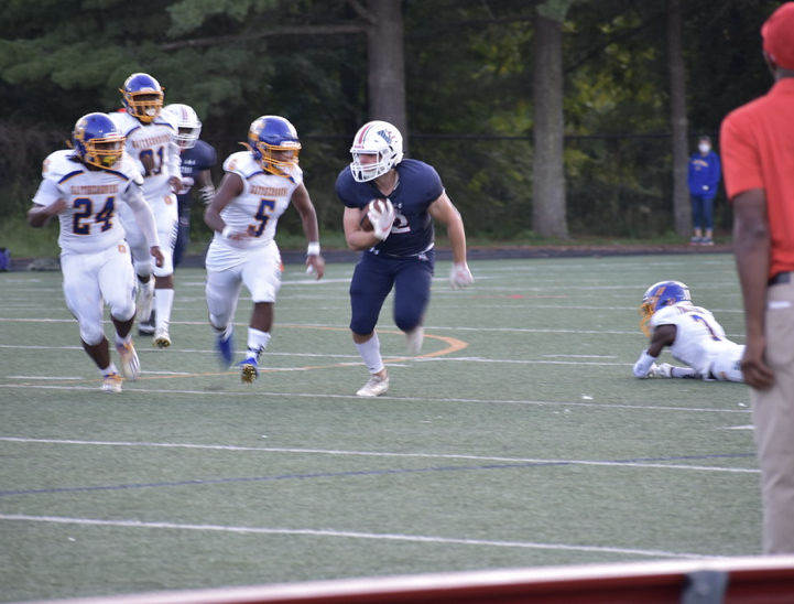 Senior running back Nate Jacobs rushes for a big gain against Gaithersburg during the 2021 home opener.
