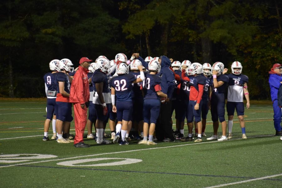 The+varsity+football+team+is+led+by+Head+Coach+Ivan+Hicks+%28pictured+here+in+all+red%29%2C+who+has+implemented+mandatory+study+hall+before+practice.