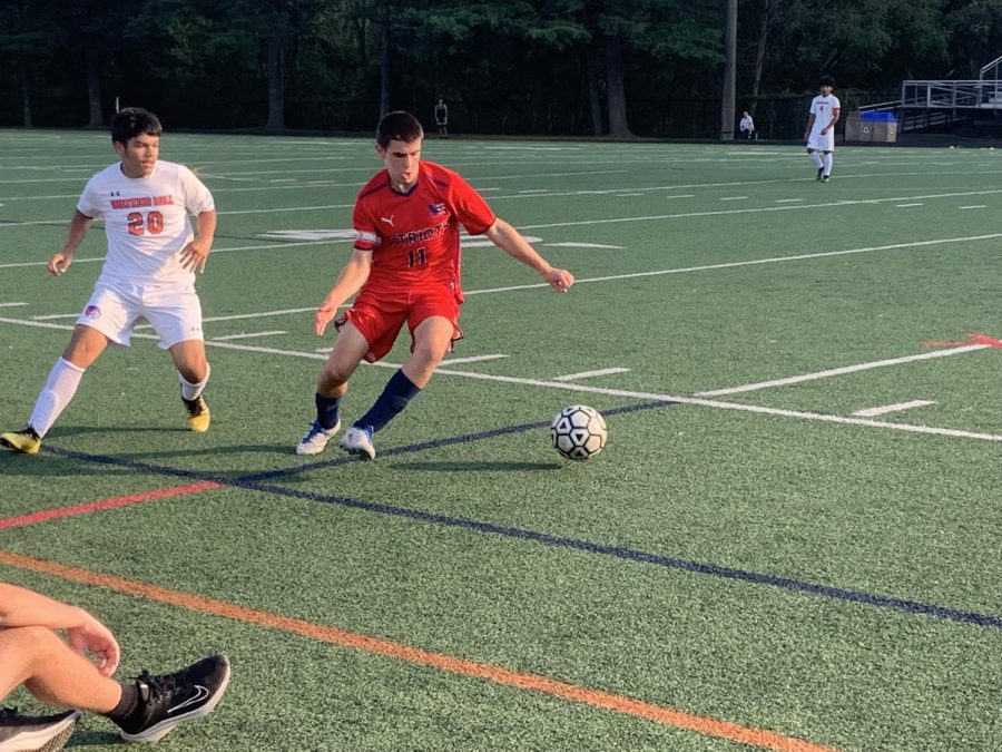 Sophomore Noah Friedman dribbles past a defender after stealing the ball in the game against Watkins Mill. Friedman scored twice this game.