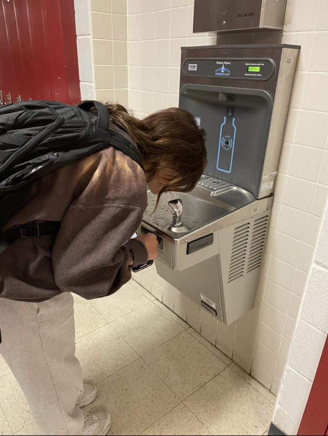 Junior Sivan Gil drinks from the water fountain in the locker banks between science hallways