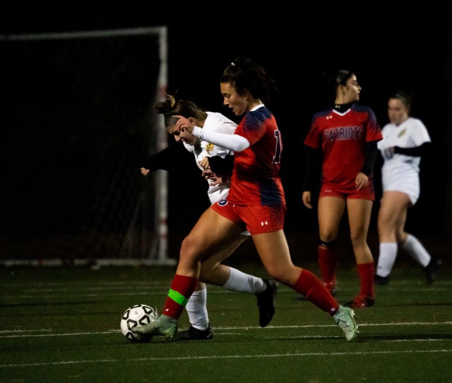 Senior Anya Sander fights for possession during the Oct. 20 senior night game with Damascus.