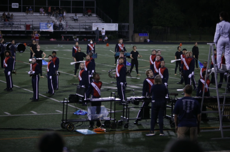 The marching band at the home football game on Sept. 9 performs the first movement of their routine.