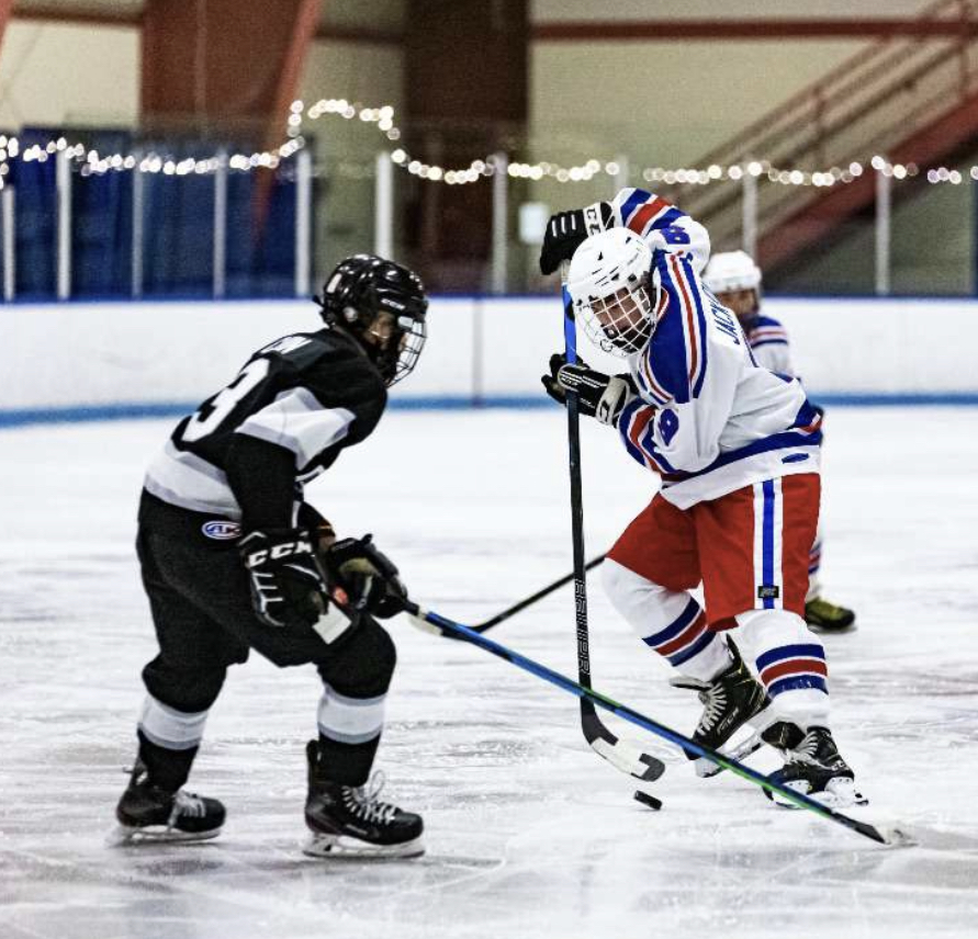 Sophomore Connor Jackson fights for a loose puck.
