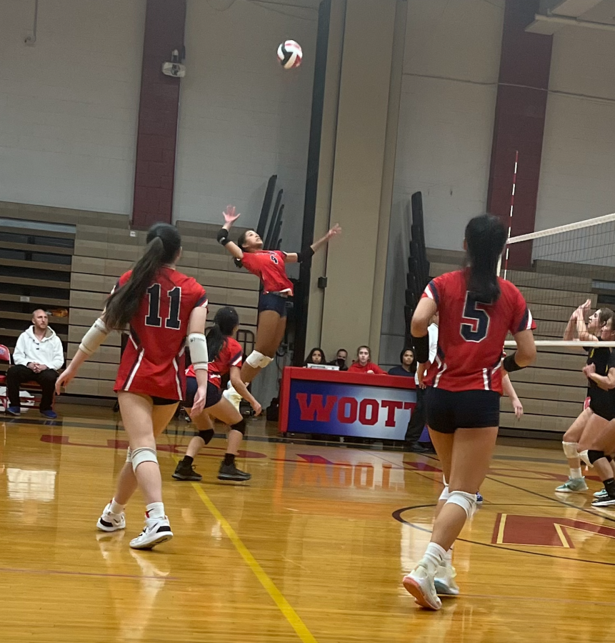 Junior Lauren Smith spikes the ball into the Rockets defense, giving the Patriots a lead in the third set.