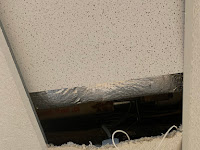 A cracked ceiling tile found in the upstairs English hallway is just one preventable hazard in the school.