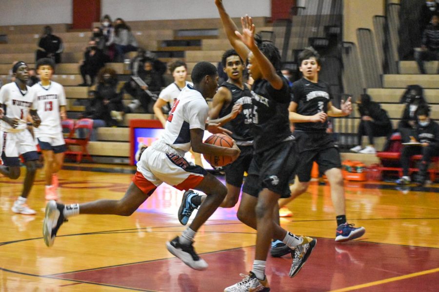 Sophomore Sammy Alexandre drives to the hoop against Northwest on Dec 9, 2021. Alexandre since has been moved up and will play on varsity this year