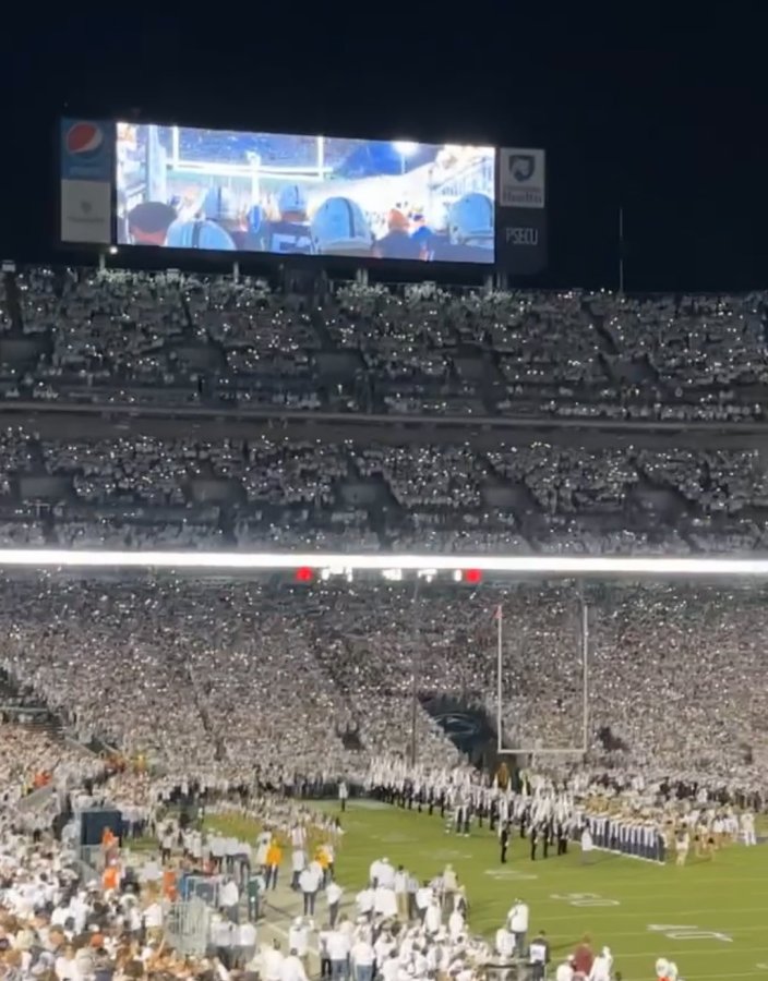 Penn State fans get hype at the white out game as the team comes out of the tunnel for the second half.