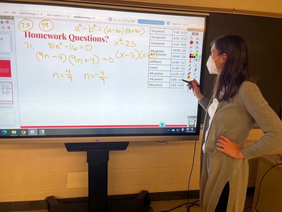 Math teacher Sarah Spillman offers help to students at the end of class.
