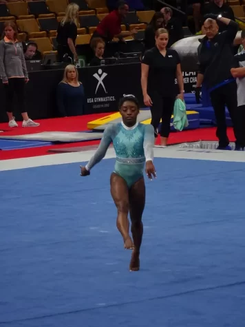 Simone Biles warms up for her floor routine when competing for Team USA.