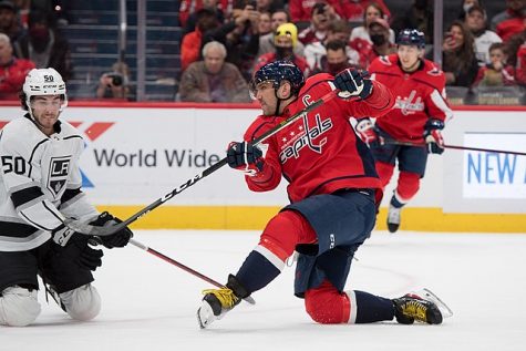 Alex Ovechkin shoots from one knee during a home game against the Los Angeles Kings.