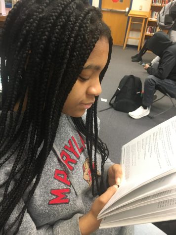 Senior Nwamaka Aniagboso reads “Multicultural Monologues for Young Actors” at the Media Center in preparation for the Black History Month Program on  Feb. 28 at 6:30 p.m. in the Commons.