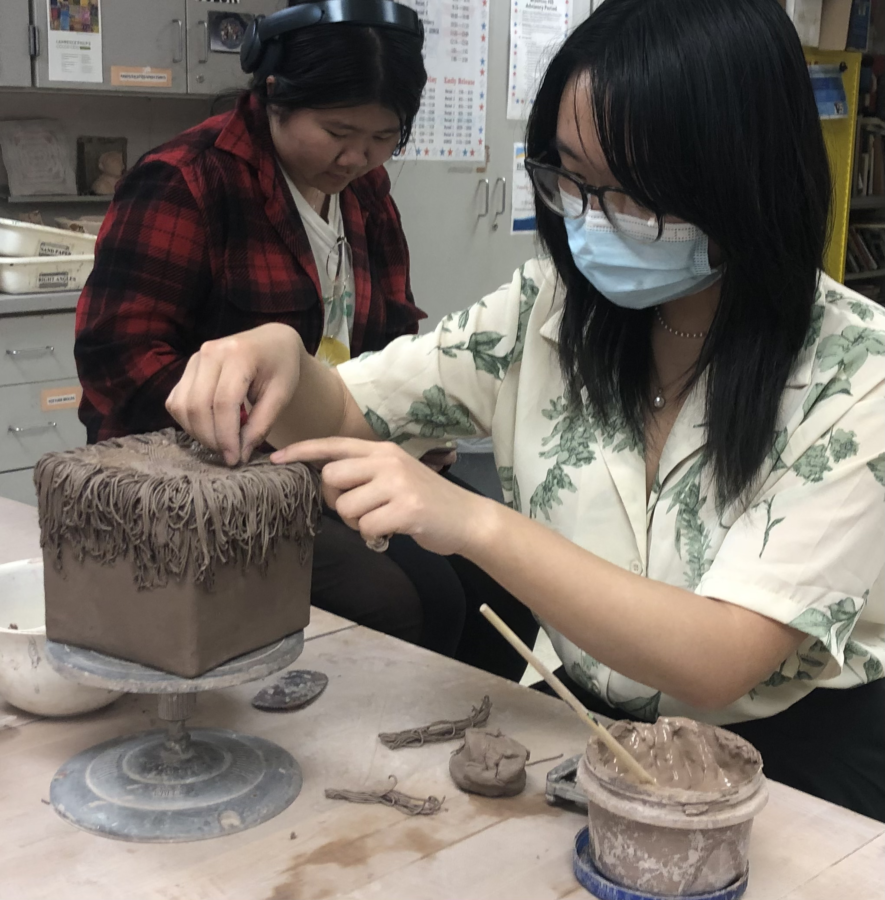 Sophomore Irina Wu works on a block of grass that she will later attach a fox sculpture to. Ceramics class teaches students to use clay and pottery as a medium of art. I like that I get to use my hands for something other than typing and writing like I do in other classes, Wu said.