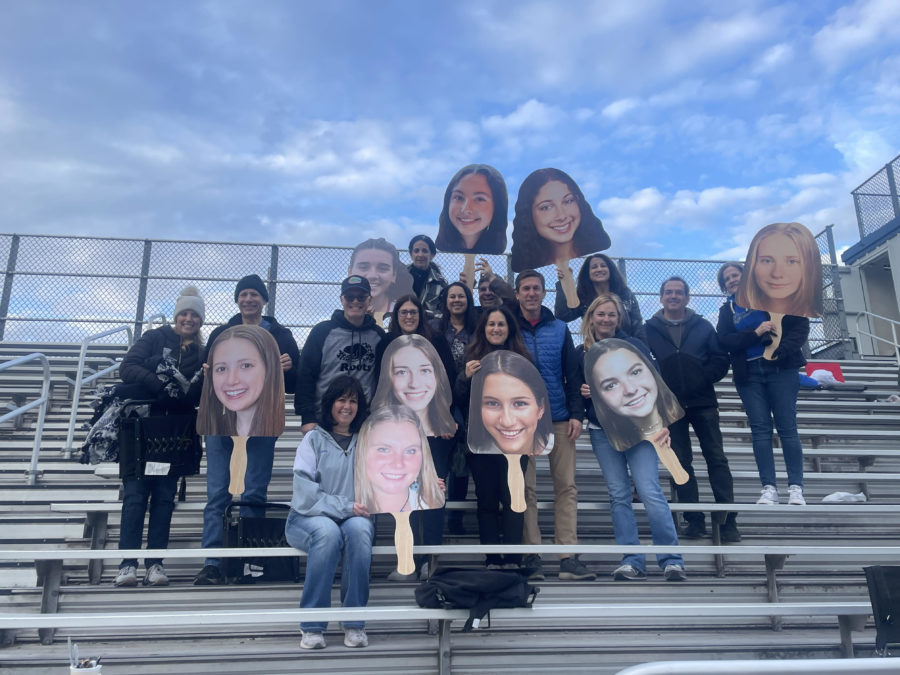 The varsity girls lacrosse parents brought giant blow up pictures of the girls heads to senior night.