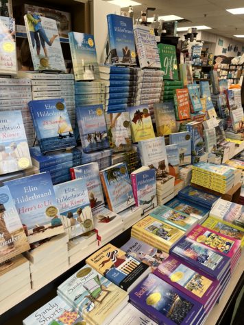 At a book store in Rehoboth Beach, Delaware, popular books are on display. Lighthearted books about vacations and romance are perfect for summer.