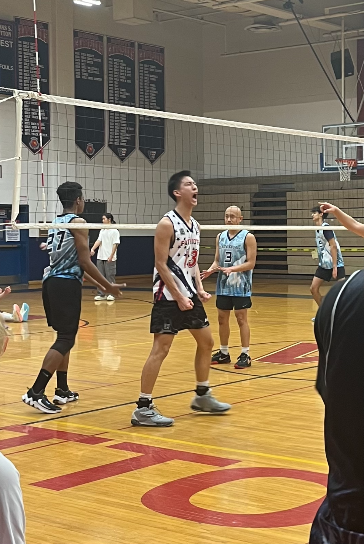 Sophomore Timothy Ouyang celebrates after spiking it through the Clarksburg defense.