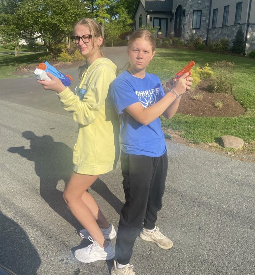 Seniors Kaitlin Mariani and Shelby Parsons draw their water guns ready to eliminate their targets in senior assassin.