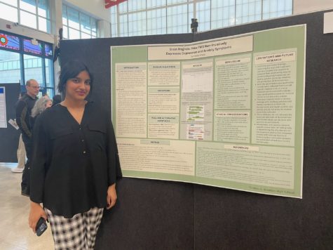 Senior Sureena Atwal attends the AP Research symposium on Apr. 26, where her poster with her research topic and results is up for display for parents, students, and teachers to view.